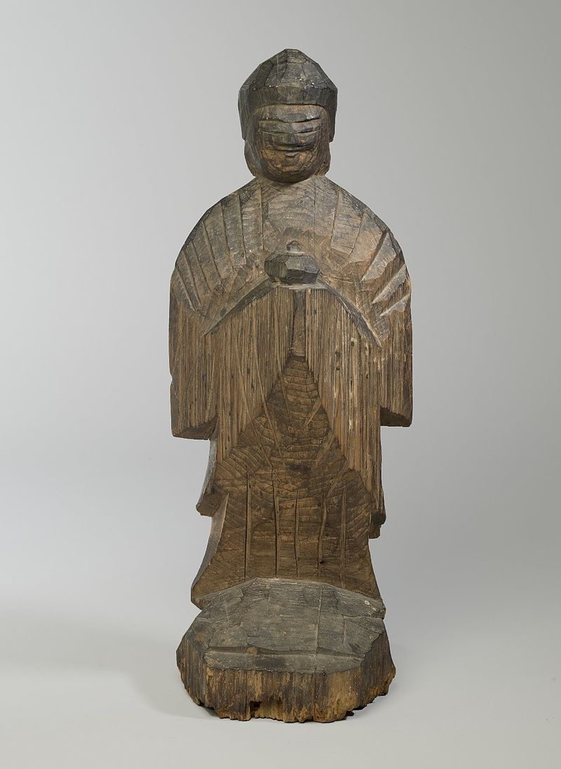 a carved wood statue of Yakushi the Medicine Buddha